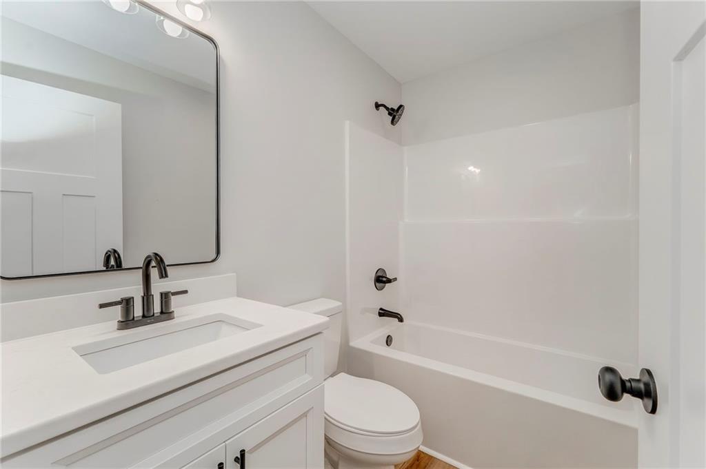 22 Earls Way Chatsworth, GA 30705 - Photo 46 of 64 a bathroom with a sink a toilet and a mirror