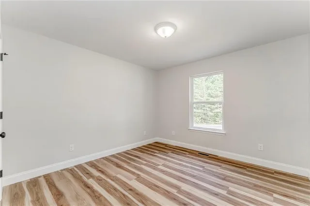 a front view of a house with a yard and potted plants