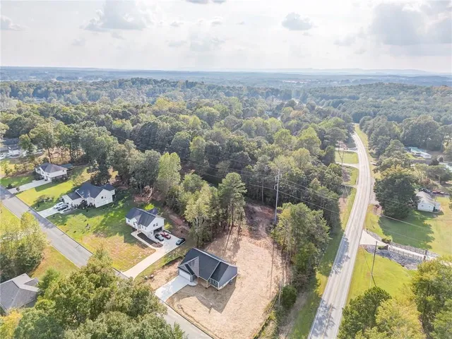 an aerial view of residential houses with outdoor space