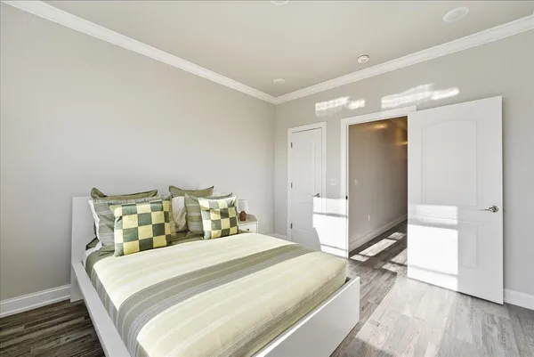 a large bed sitting in a bedroom next to a window