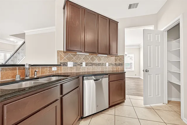 a kitchen with stainless steel appliances granite countertop a sink and a stove