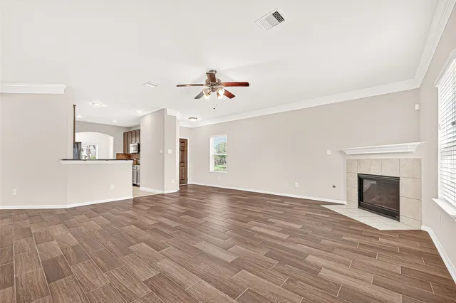 wooden floor in an empty room with a fireplace