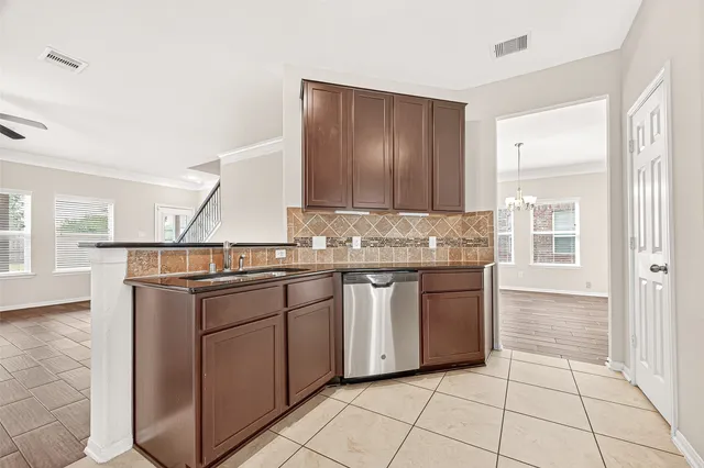 a kitchen with stainless steel appliances granite countertop a sink and cabinets