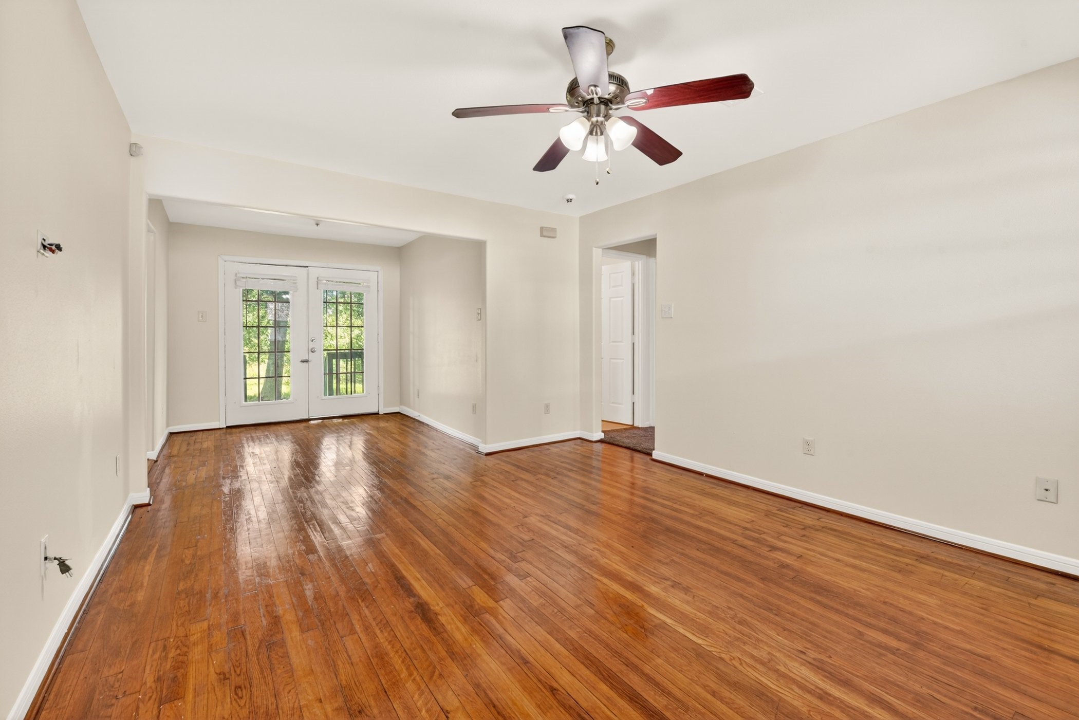 7013 St Augustine Street Houston, TX 77021 - Photo 7 of 35 a view of an empty room with wooden floor and a window