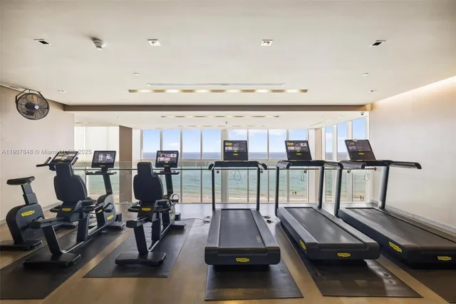 a room with gym equipment and a large window