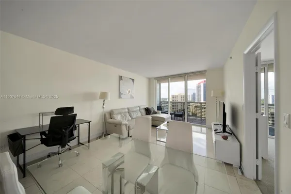 a living room with furniture large window and flat screen tv