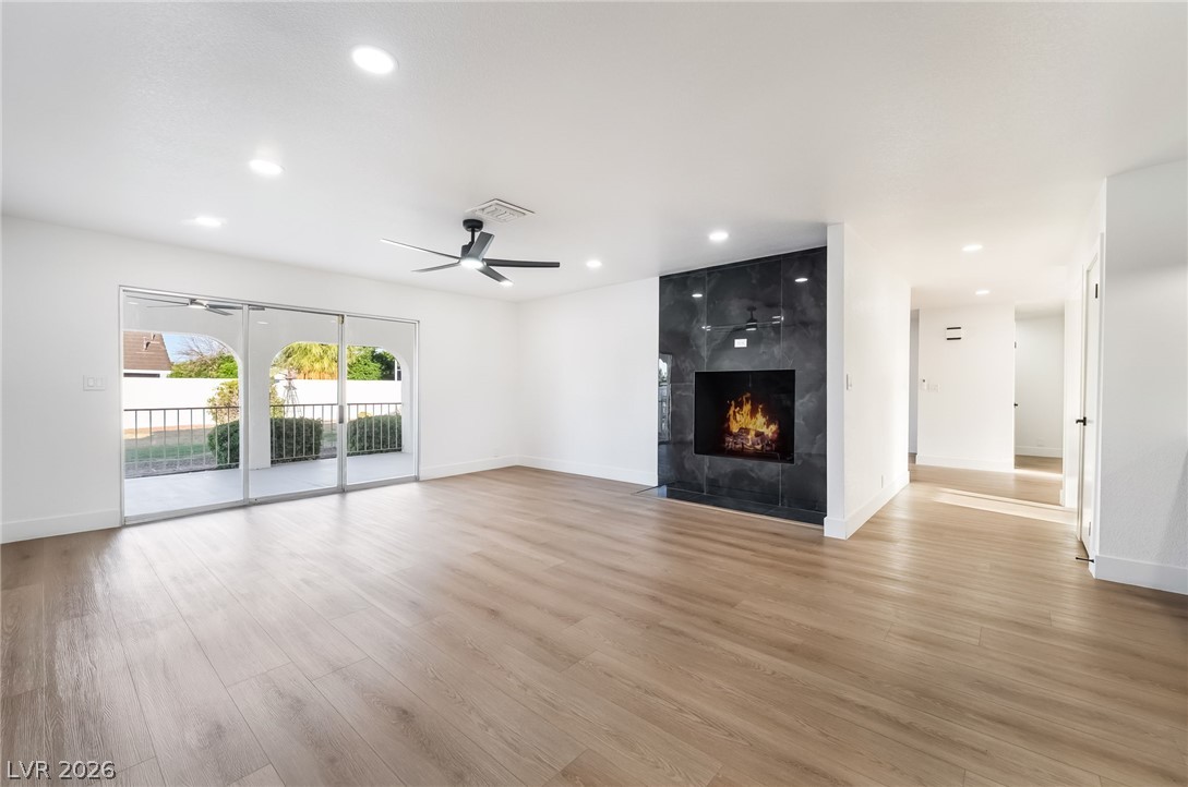 429 Crestway Road Henderson, NV 89015 - Photo 13 of 56 A spacious, naturally illuminated great room offers seamless outdoor access and a modern fireplace feature.