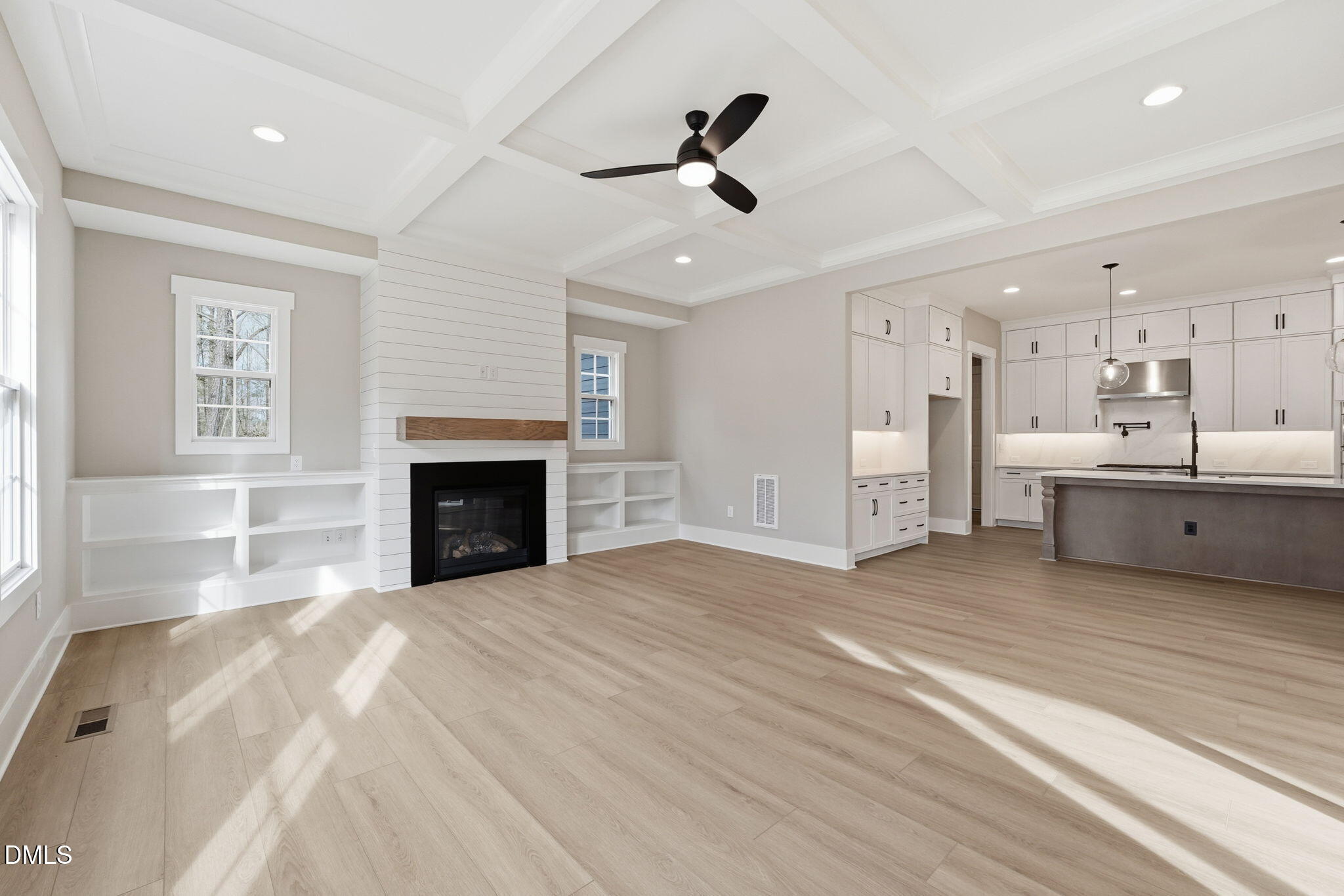 318 Ivy Rdg Road Chapel Hill, NC 27516 - Photo 9 of 47 a view of a livingroom with a fireplace a ceiling fan and windows