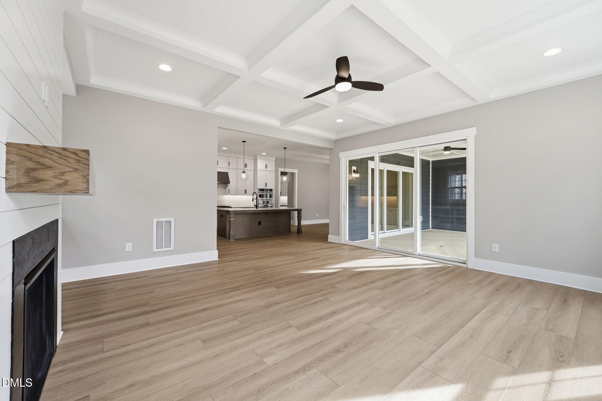 318 Ivy Rdg Road Chapel Hill, NC 27516 - Photo 10 of 47 a view of an empty room with wooden floor and a fireplace