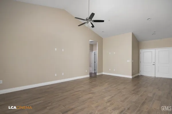 a view of an empty room with a ceiling fan