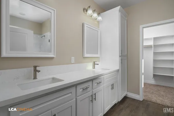 a bathroom with double sink and a mirror