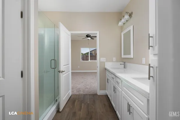 a bathroom with a double vanity sink and mirror