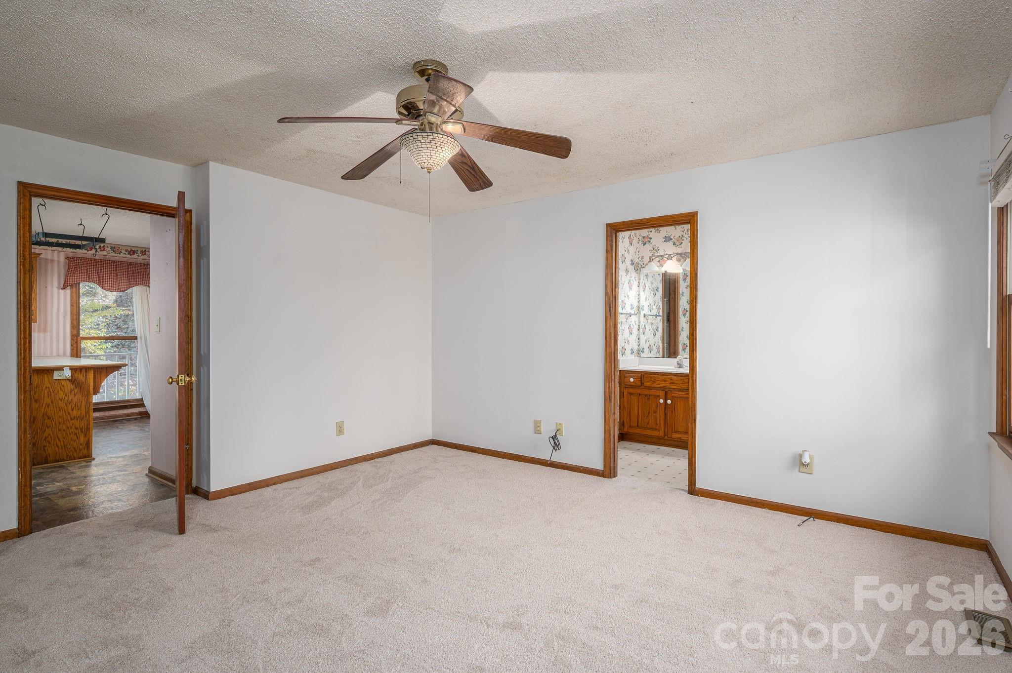 480 South Ingleside Farm Road Iron Station, NC 28080 - Photo 14 of 42 an empty room with windows and fan