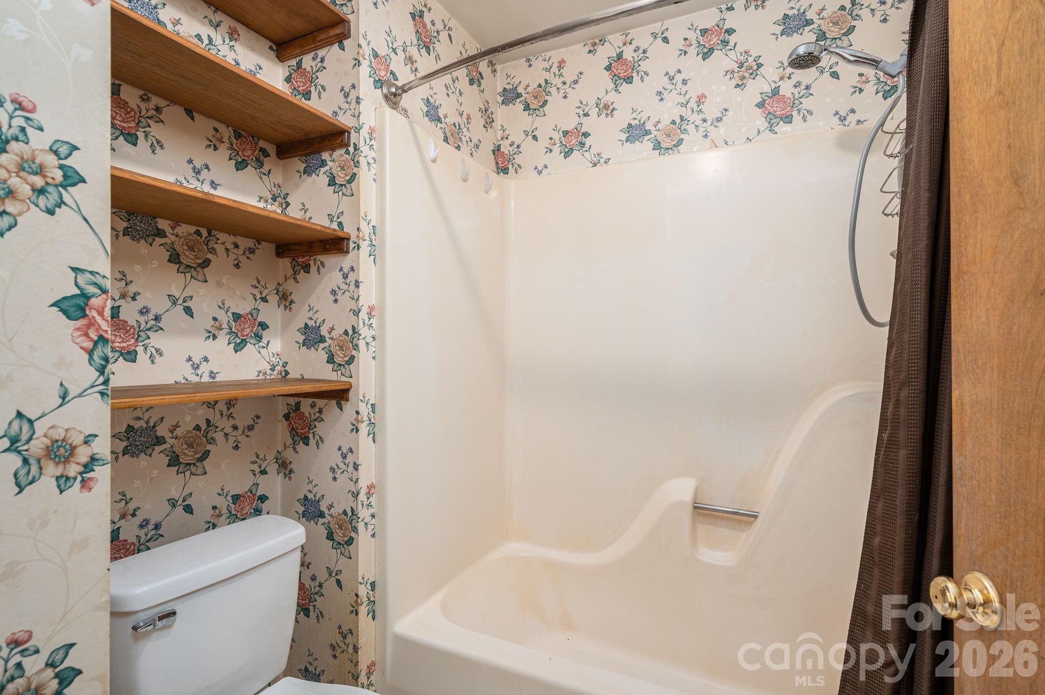 480 South Ingleside Farm Road Iron Station, NC 28080 - Photo 16 of 42 a bathroom with a toilet and a shower curtain