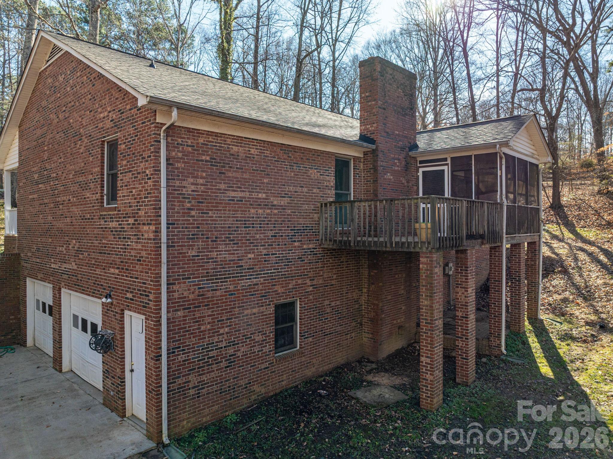 480 South Ingleside Farm Road Iron Station, NC 28080 - Photo 32 of 42 a view of a brick house with a small yard and large tree