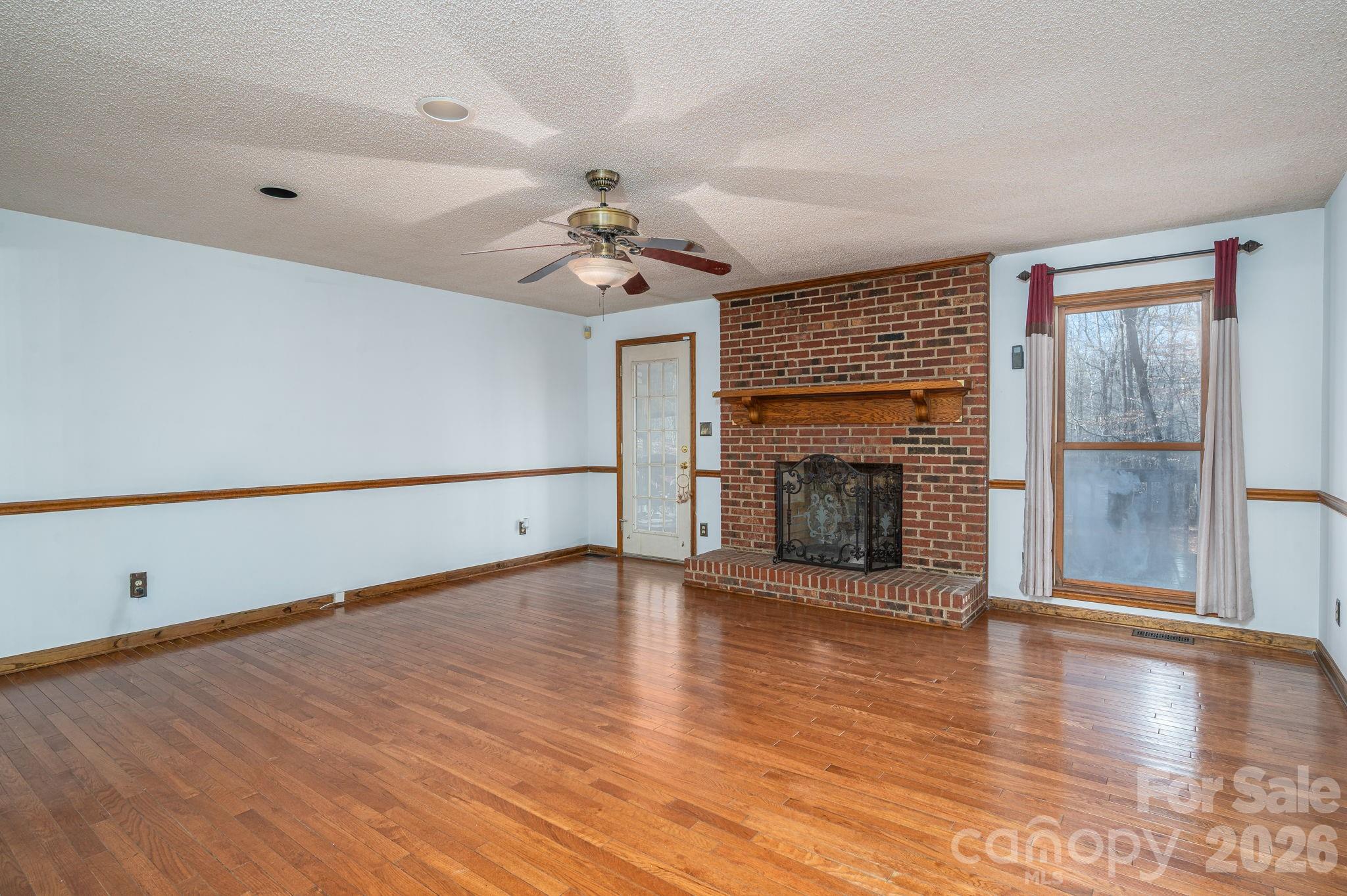 480 South Ingleside Farm Road Iron Station, NC 28080 - Photo 5 of 42 a view of an empty room with glass door and wooden floor