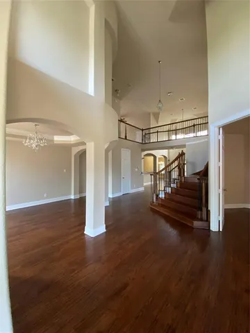 a view of staircase and living room with wooden floor