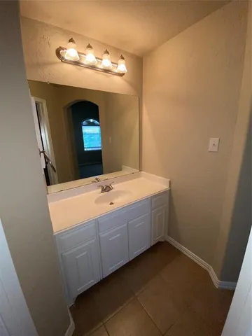 an empty room with staircase and a ceiling fan