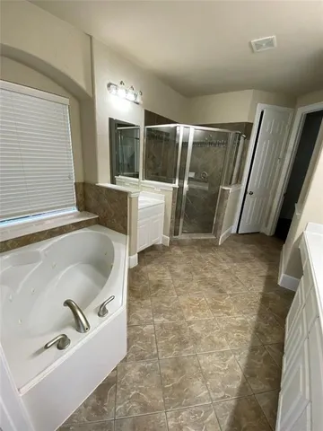 a bathroom with a sink mirror and shower