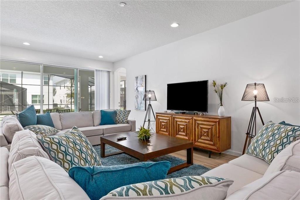 2626 Calistoga Avenue Kissimmee, FL 34741 - Photo 11 of 43 a living room with furniture and a flat screen tv