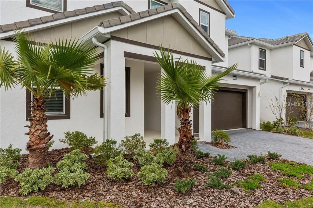 2626 Calistoga Avenue Kissimmee, FL 34741 - Photo 2 of 43 a front view of a house with a plant