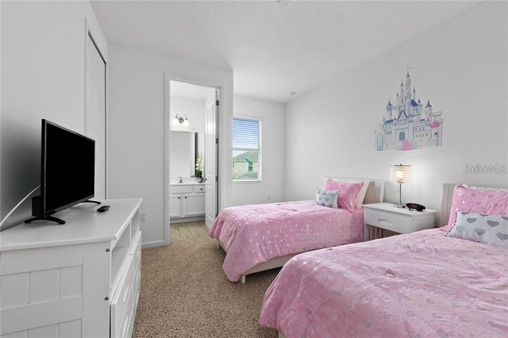 2626 Calistoga Avenue Kissimmee, FL 34741 - Photo 23 of 43 a bedroom with two bed and a flat screen tv