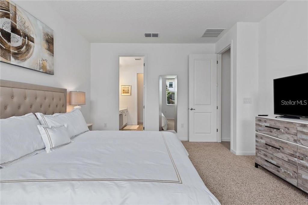 2626 Calistoga Avenue Kissimmee, FL 34741 - Photo 26 of 43 a bedroom with a bed and a flat screen tv