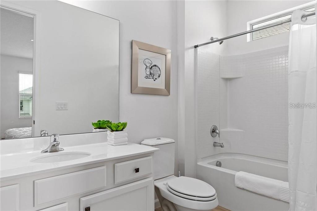 2626 Calistoga Avenue Kissimmee, FL 34741 - Photo 30 of 43 a bathroom with a granite countertop toilet sink and a bathtub