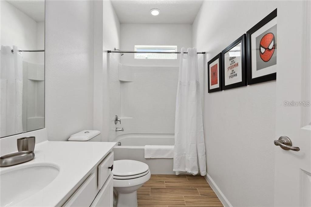 2626 Calistoga Avenue Kissimmee, FL 34741 - Photo 31 of 43 a bathroom with a toilet sink and vanity