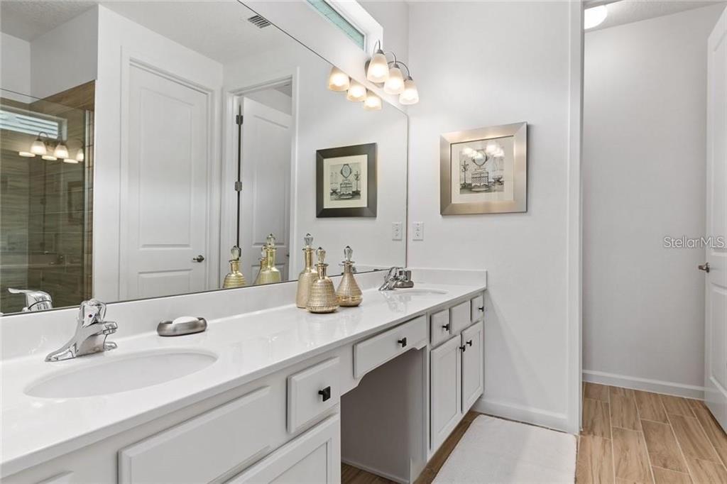 2626 Calistoga Avenue Kissimmee, FL 34741 - Photo 33 of 43 a bathroom with a sink and a mirror