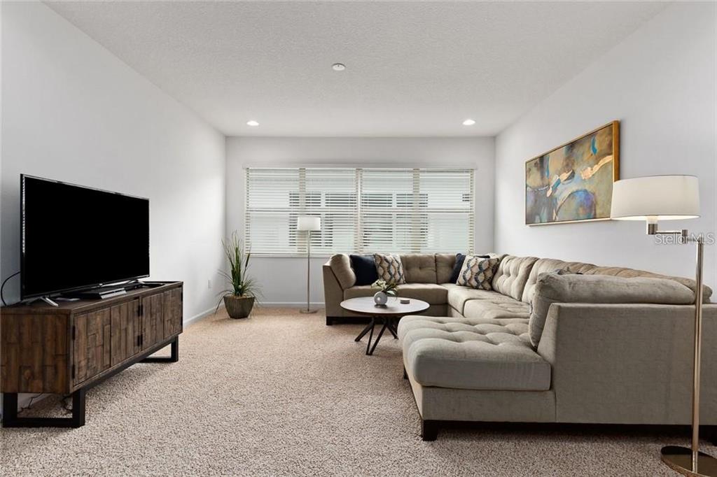 2626 Calistoga Avenue Kissimmee, FL 34741 - Photo 39 of 43 a living room with furniture and a flat screen tv