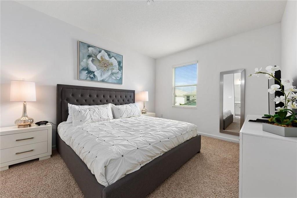 2626 Calistoga Avenue Kissimmee, FL 34741 - Photo 40 of 43 a bedroom with a bed and walk in closet