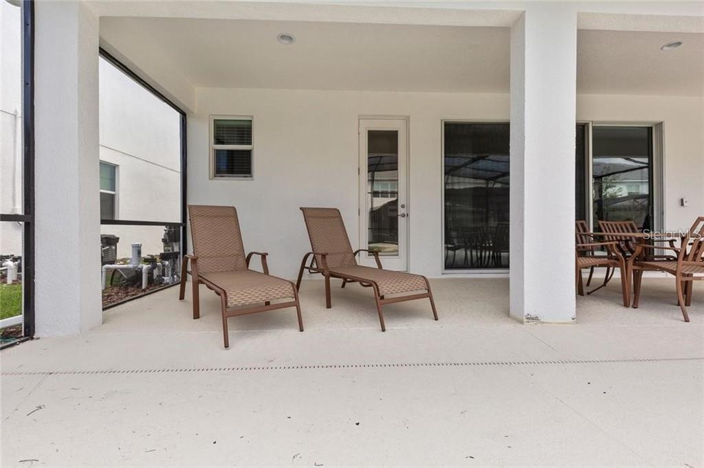 2626 Calistoga Avenue Kissimmee, FL 34741 - Photo 41 of 43 a living room with furniture and a table