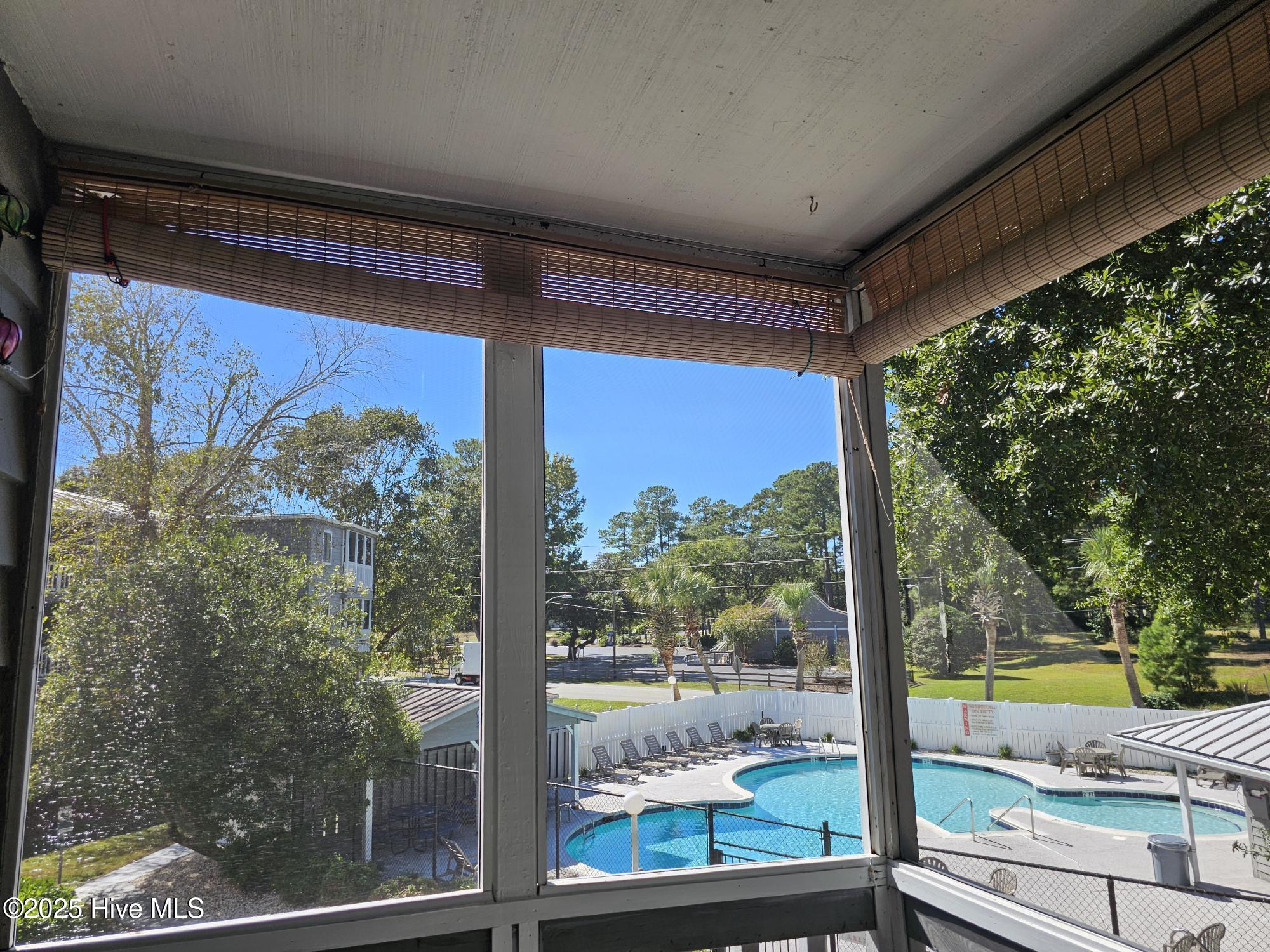 10172 Beach Drive Southwest, Unit 2206 Calabash, NC 28467 - Photo 28 of 53 Pool View from Screened in Porch