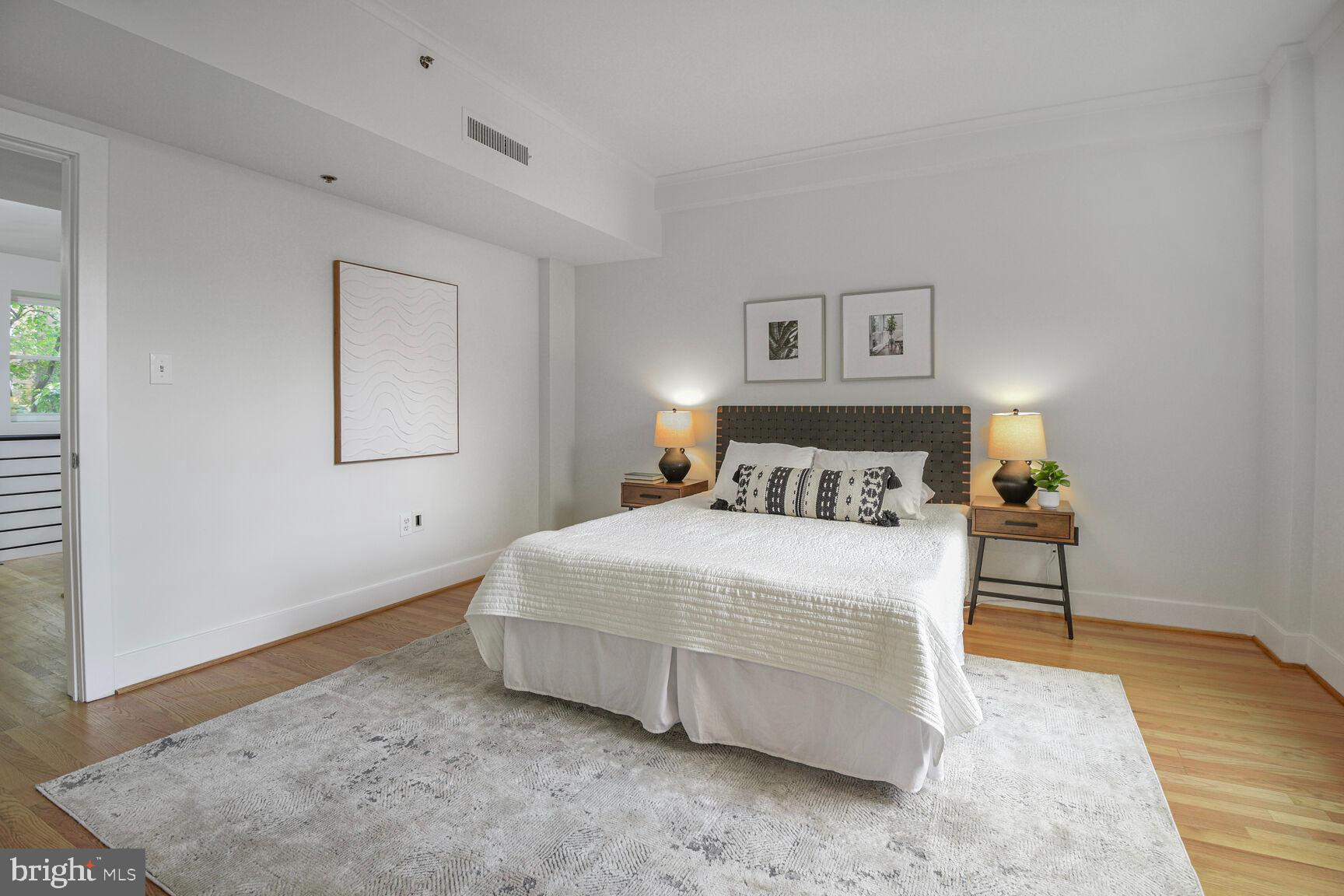 1437 Rhode Island Avenue Northwest, Unit 101 Washington, DC 20005 - Photo 12 of 36 a bedroom with a bed and a night stand