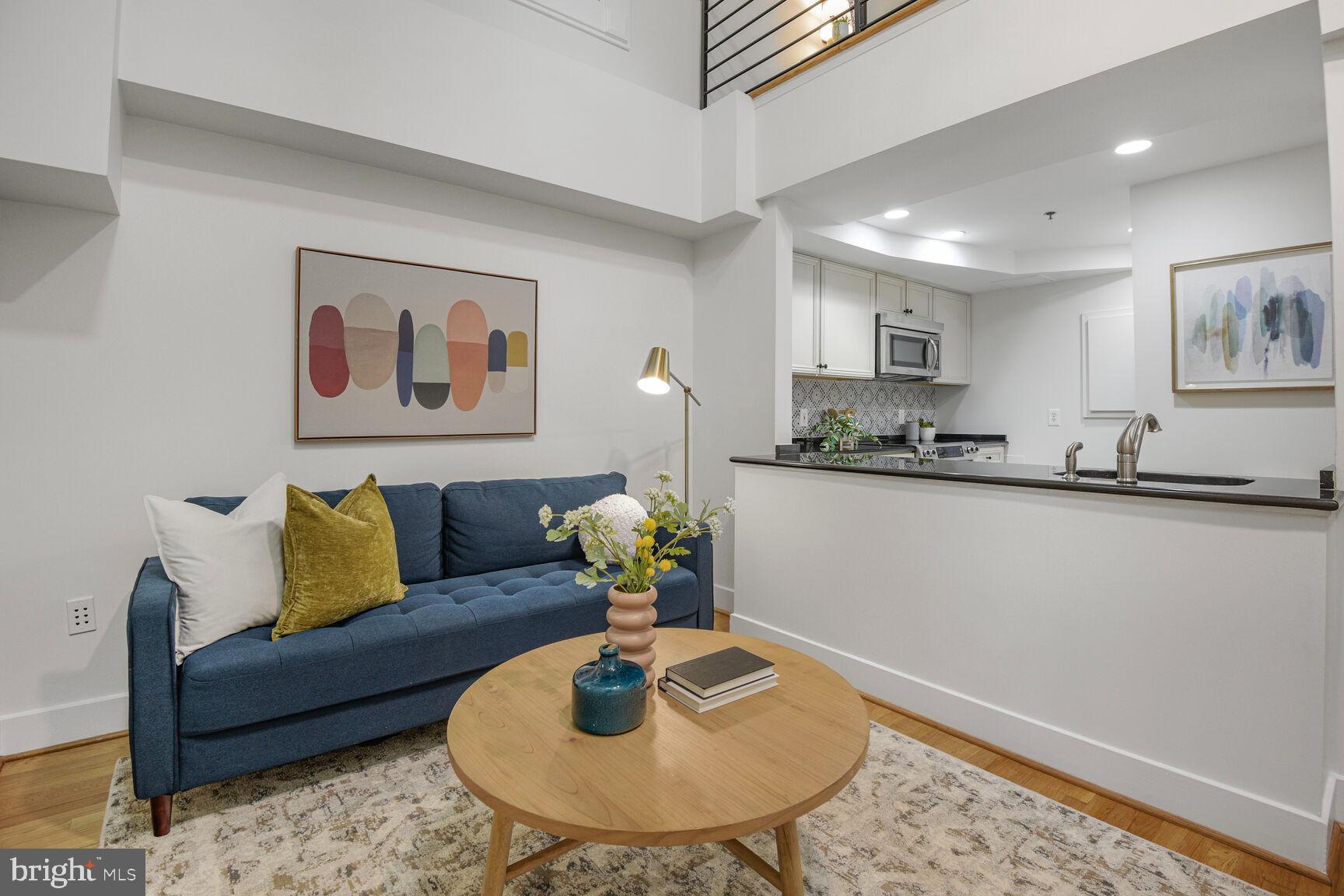 1437 Rhode Island Avenue Northwest, Unit 101 Washington, DC 20005 - Photo 3 of 36 a living room with furniture and a dining table