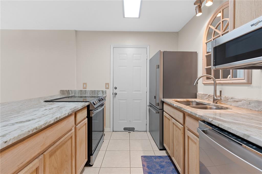 2302 South Maki Road, Unit 66 Plant City, FL 33563 - Photo 15 of 35 a kitchen with stainless steel appliances granite countertop a sink stove and refrigerator
