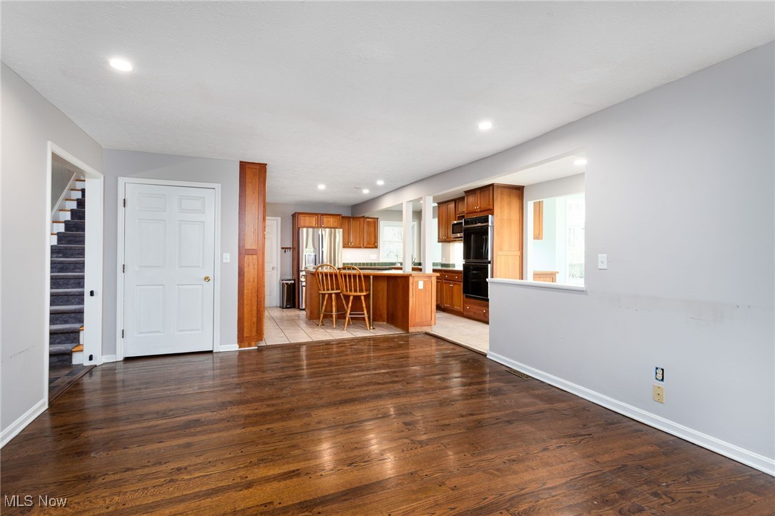 14566 West Ridge Road Novelty, OH 44072 - Photo 20 of 49 Unfurnished living room with recessed lighting, light wood-style floors, baseboards, and stairs