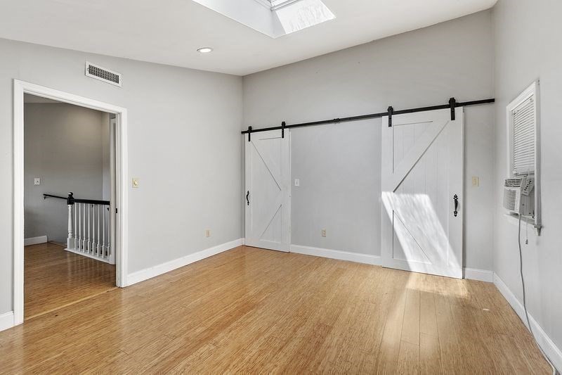 150 Windsor Avenue Swampscott, MA 01907 - Photo 14 of 39 a view of an empty room with wooden floor and a window