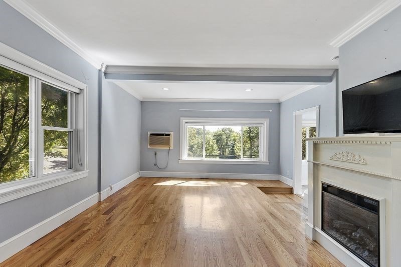 150 Windsor Avenue Swampscott, MA 01907 - Photo 7 of 39 a view of empty room with wooden floor and fireplace