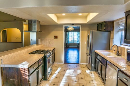 512 Amanda Street Ridgecrest, CA 93555 - Photo 9 of 44 a kitchen with stainless steel appliances granite countertop a sink stove and refrigerator