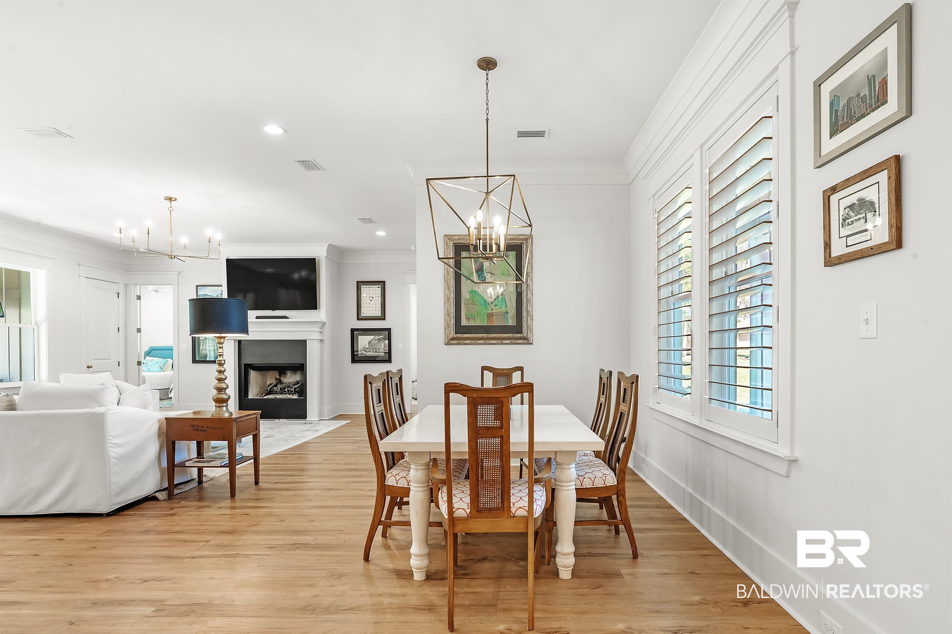 27888 Oakachoy Loop Daphne, AL 36526 - Photo 19 of 65 Dining area with light wood-type flooring, an inviting chandelier, ornamental molding, baseboards, and visible vents
