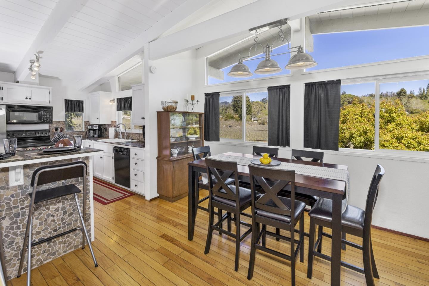 757 Pleasant Valley Road Aptos, CA 95003 - Photo 15 of 41 a view of a dining room with furniture large windows and wooden floor