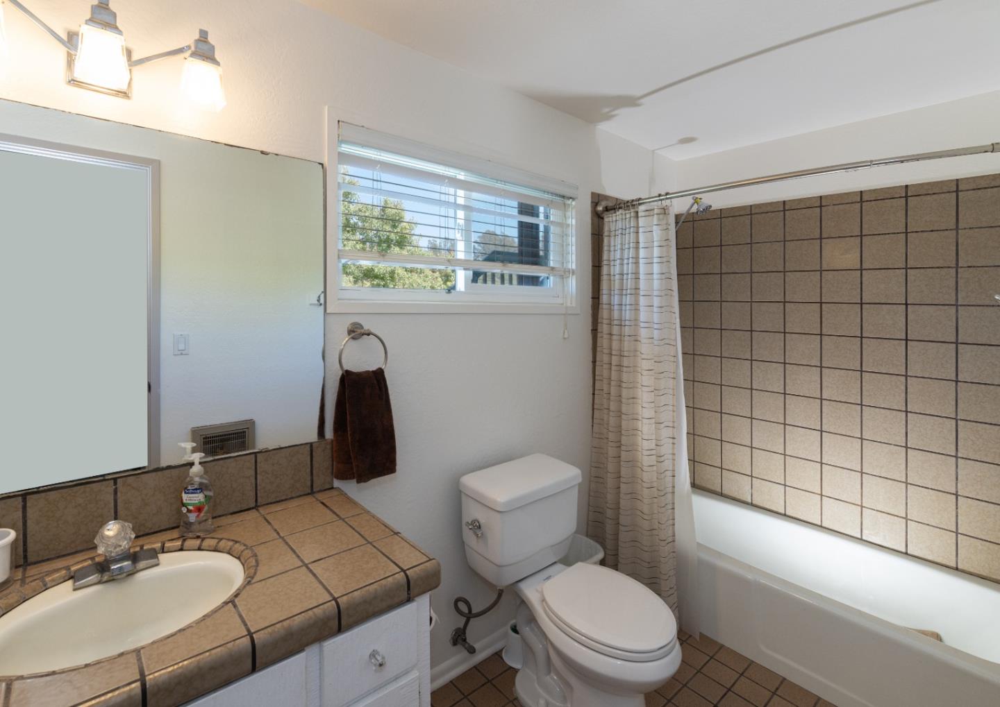 757 Pleasant Valley Road Aptos, CA 95003 - Photo 31 of 41 a white toilet sitting next to a bathroom sink