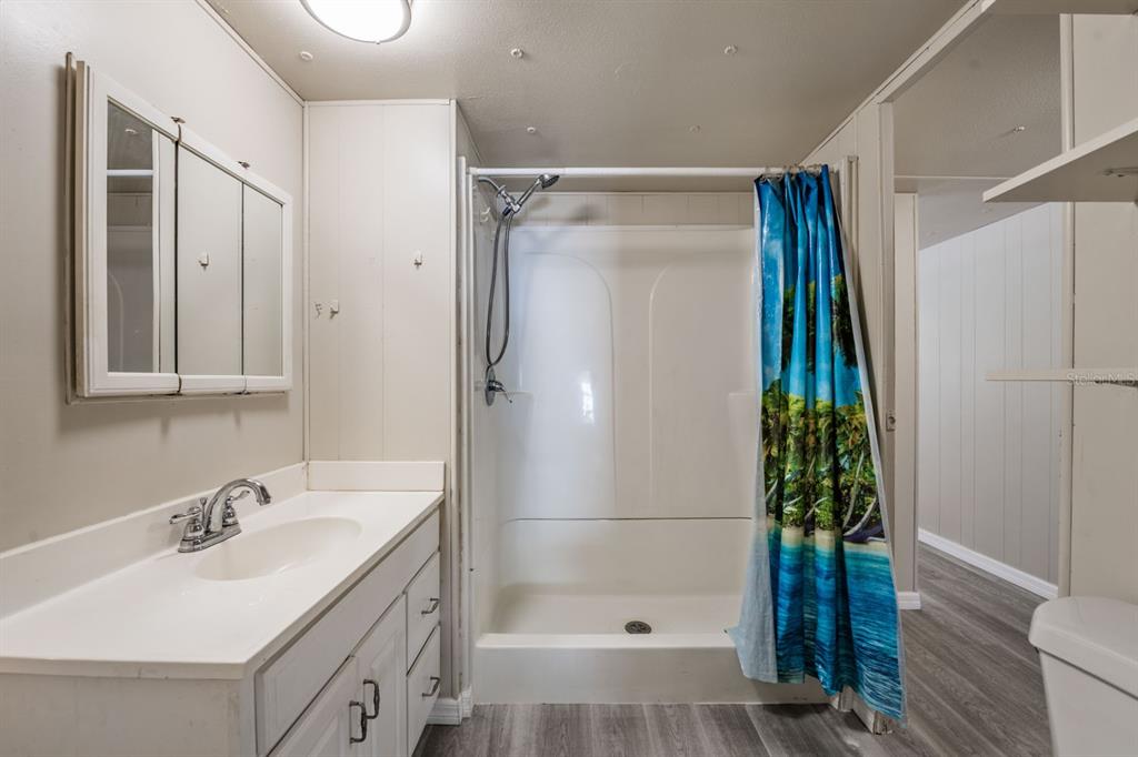 9739 Ray Street Hudson, FL 34669 - Photo 21 of 36 a bathroom with a sink toilet and shower