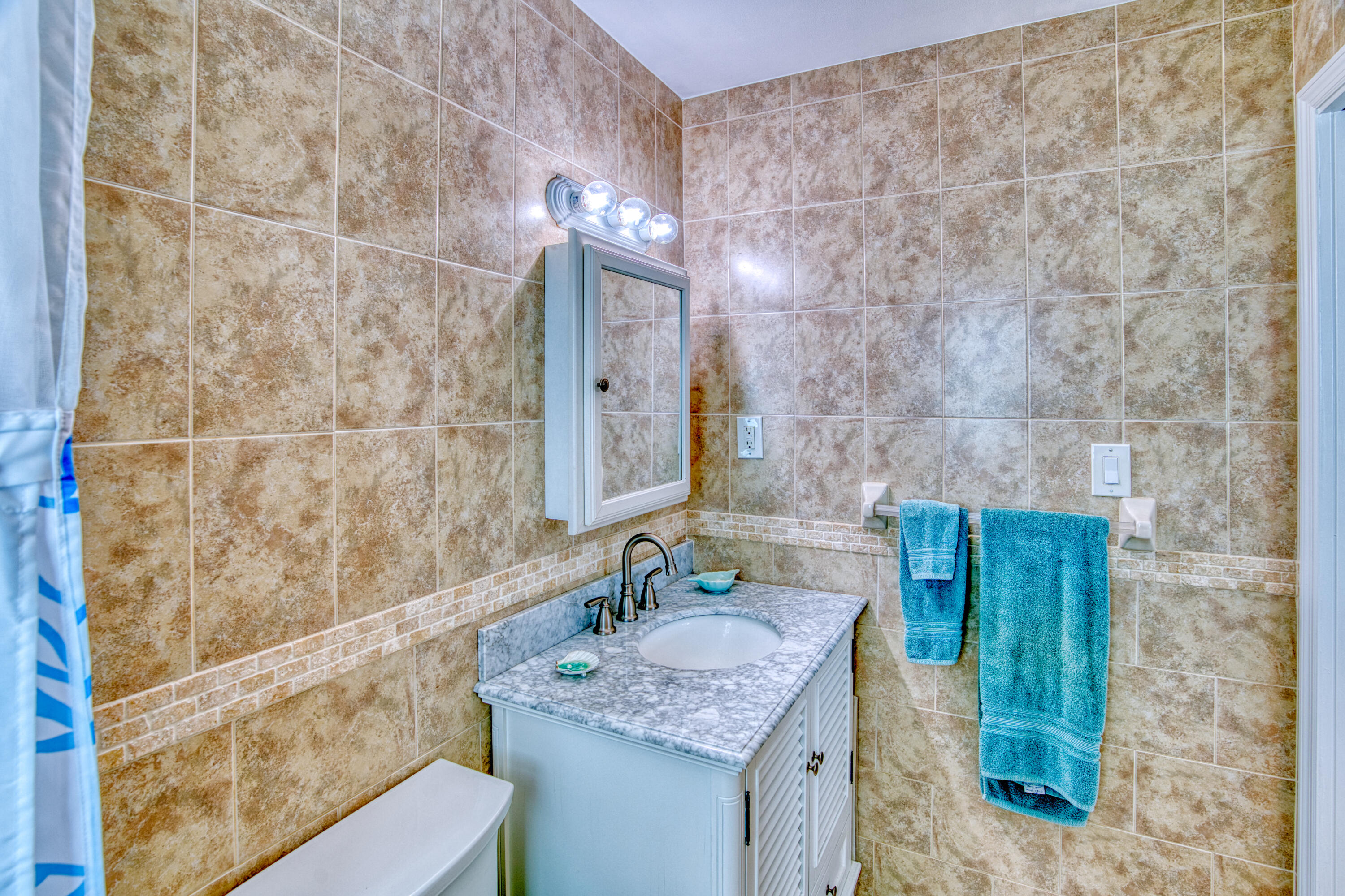 330-340 4th Street Key Colony Beach, FL 33051 - Photo 30 of 68 a bathroom with a granite countertop sink a mirror and shower