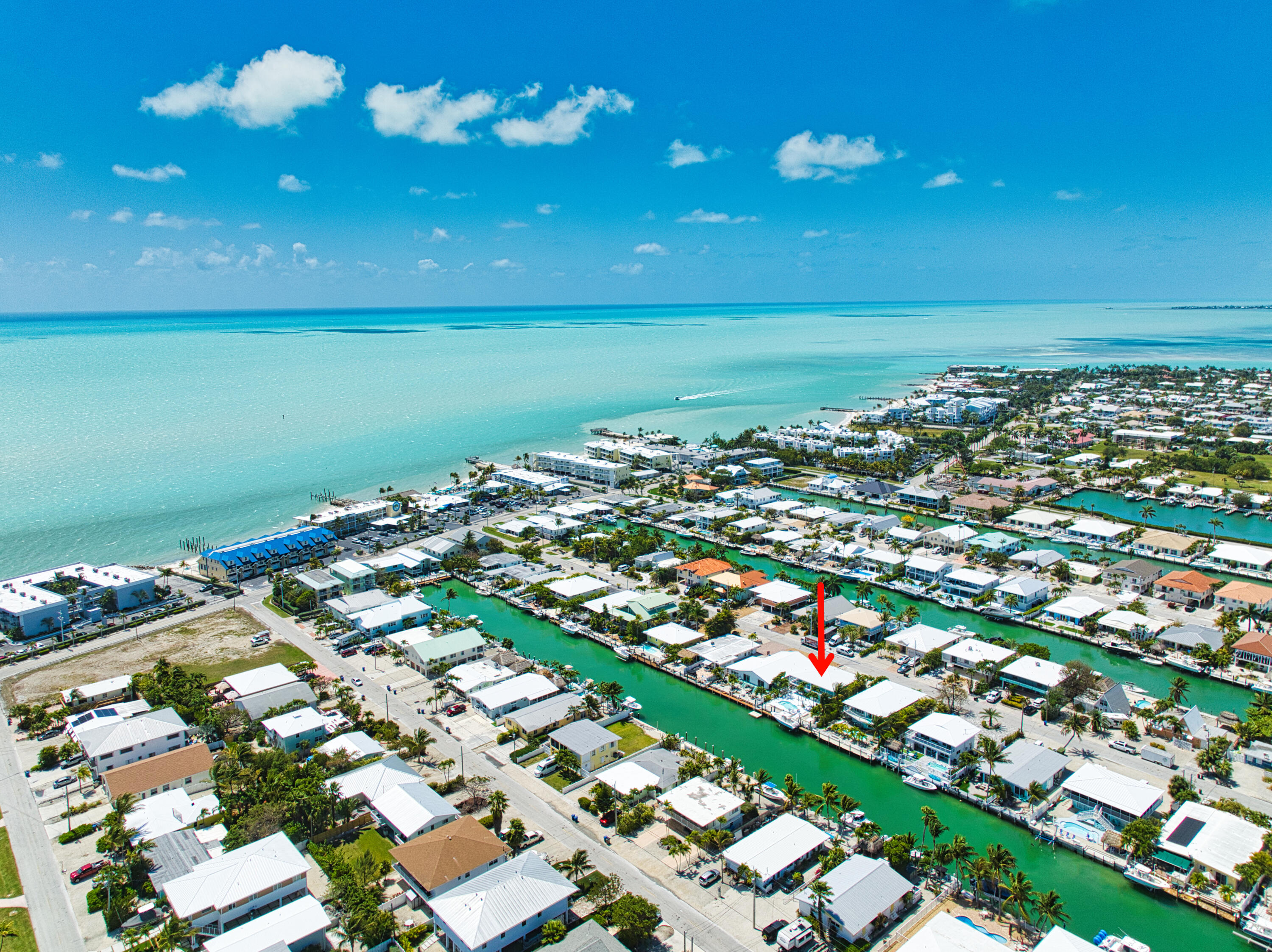 330-340 4th Street Key Colony Beach, FL 33051 - Photo 3 of 68 an aerial view of a city with lots of residential buildings and ocean view in back