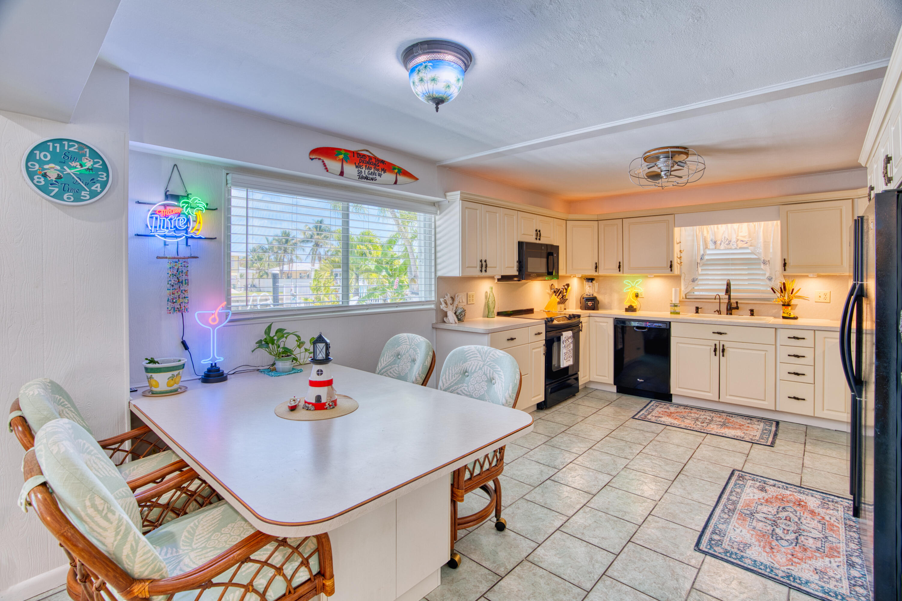 330-340 4th Street Key Colony Beach, FL 33051 - Photo 39 of 68 a open dining room with stainless steel appliances a dining table and chairs with the bookshelf