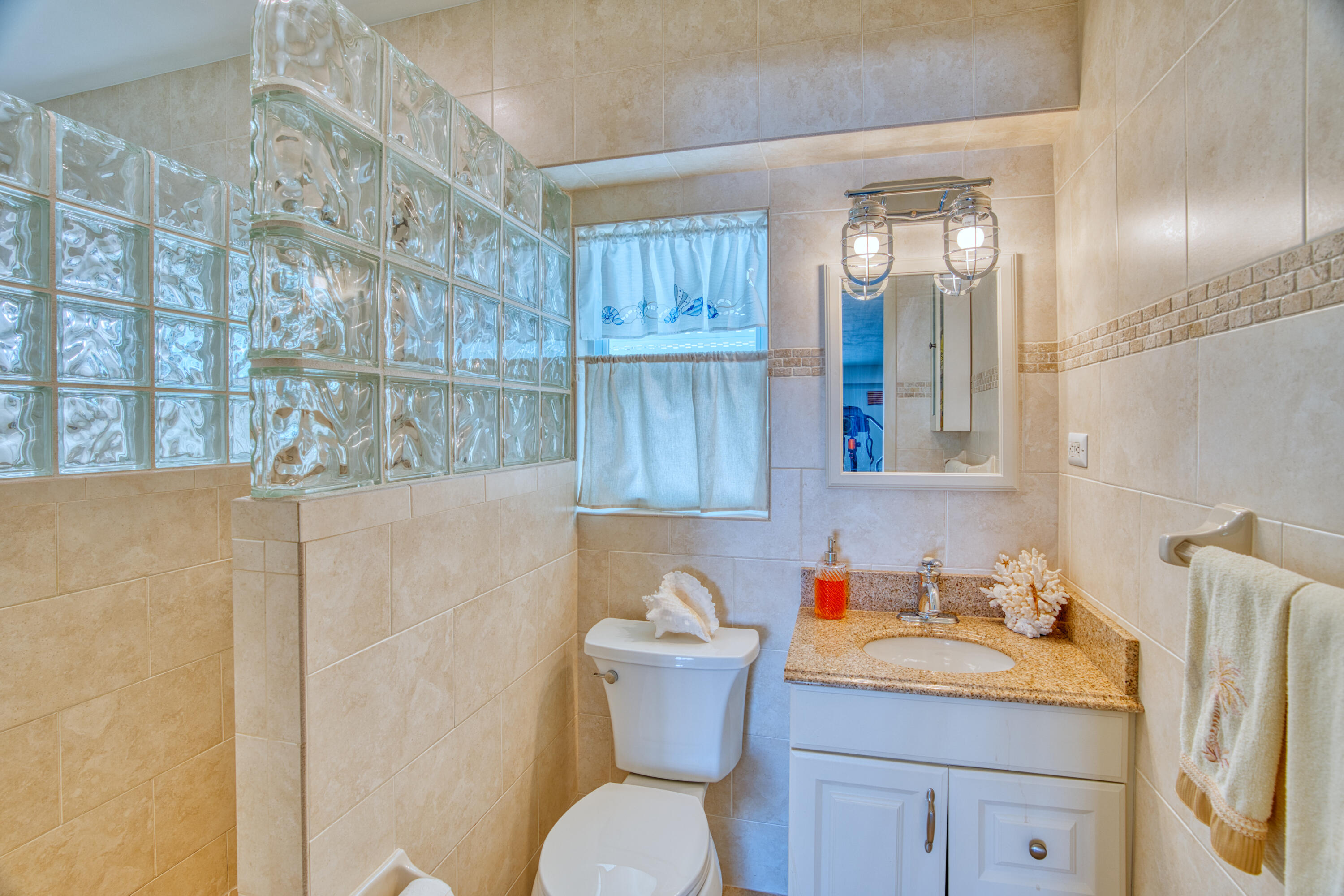330-340 4th Street Key Colony Beach, FL 33051 - Photo 47 of 68 a bathroom with a sink vanity mirror and toilet