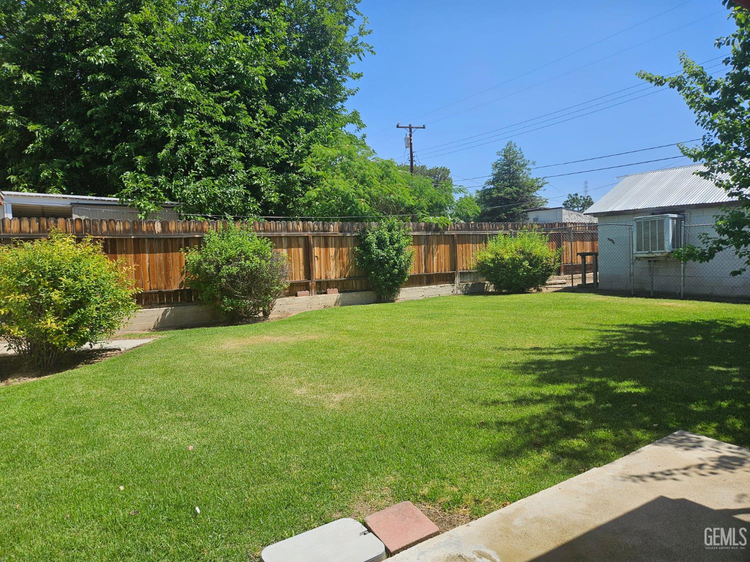 Undisclosed Address Bakersfield, CA 93306 - Photo 21 of 27 a view of a garden with a house